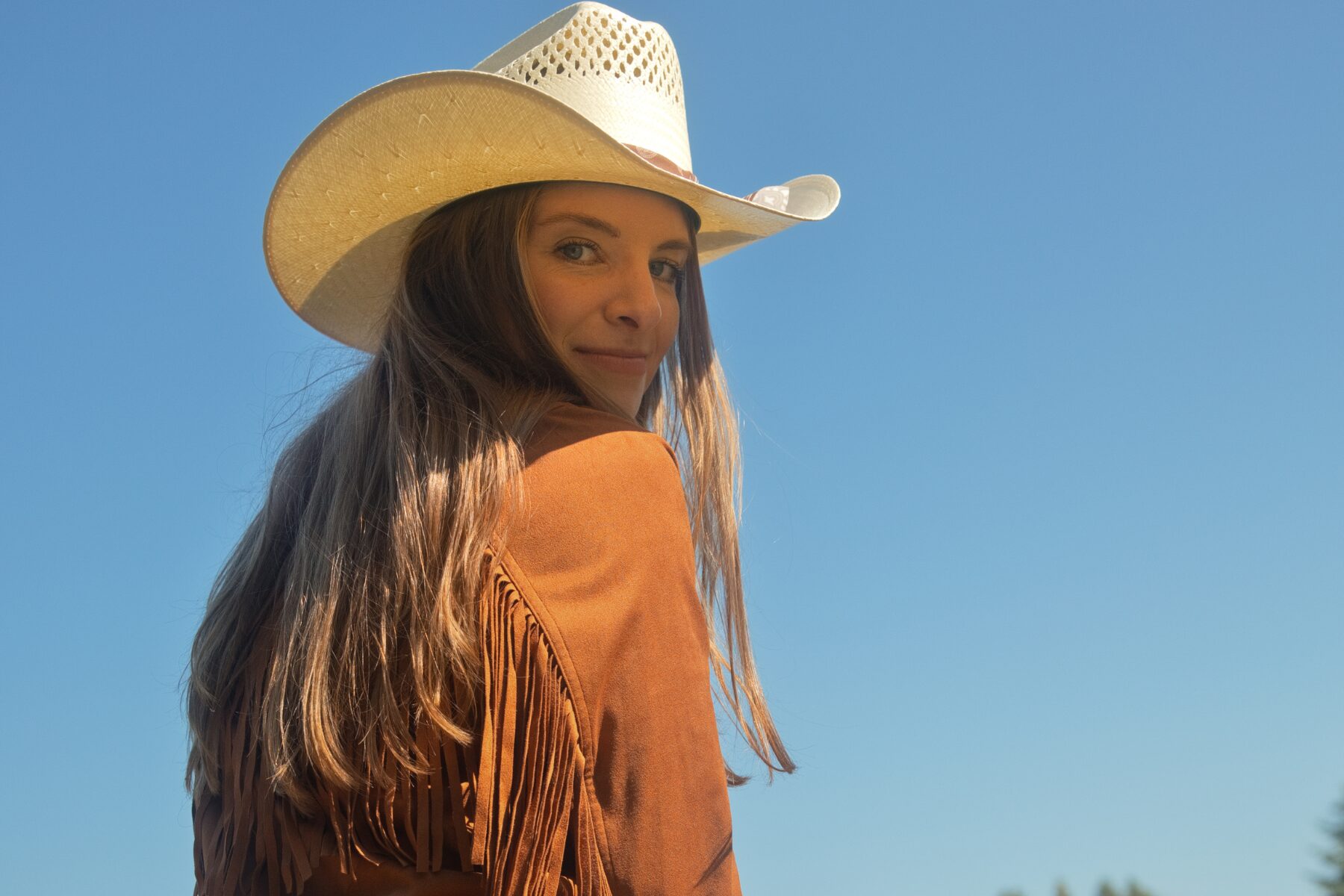 Editorial collage from an Idyllwind brand collaboration featuring a cowgirl on horseback, western boots, fringe jacket, denim, and Americana-inspired lifestyle photography in Wisconsin.